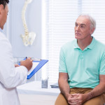 Doctor writing on clipboard in clinic